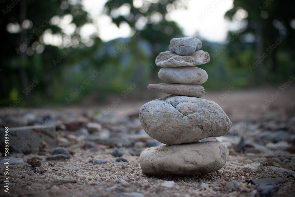 Zen Stones / Zen stone on beach for perfect meditation. Calm zen meditate background with rock pyramid on sand Zen Stones / Zen stone on beach for perfect meditation. Calm zen meditate background with rock pyramid on sand