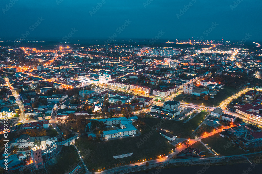 Grodno, Belarus. Night Aerial View Of Hrodna Cityscape Skyline. Famous Historic Landmarks In Lightning. Castles, Theater, Francis Xavier Cathedral, Catholic Church Of Discovery Of Holy Cross