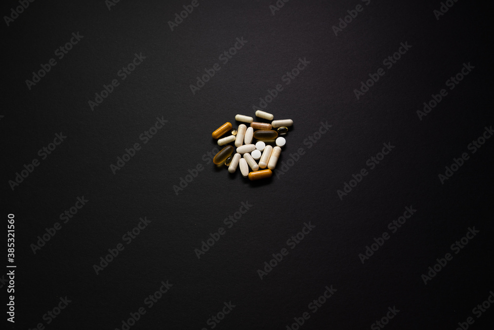 Different medicine pills, tablets on BLACK background. Many pills and tablets with space for text. Health care. Top view. Copy space. New image. Pharmaceutical picture. Closeup. Close-up. Soft focus