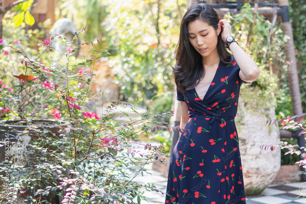 Playful and beautiful girl on warm sunny day. Woman with gorgeous smile having fun in blooming garden. Portrait of Female with dress on natural background in autumn. Playful and beautiful girl on warm sunny day. Woman with gorgeous smile having fun in blooming garden. Portrait of Female with dress on natural background in autumn.