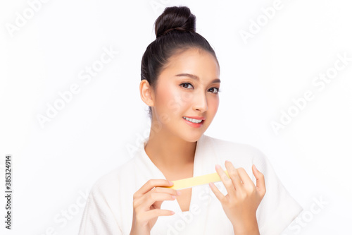 Pretty girl file her beautiful fingernail and looking at camera with happy and smile face. Beautiful young asian woman wear bathrobe. nail care manicure concept. isolated on white background