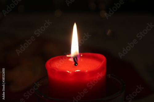 A bright candle shining during Christmas eve 