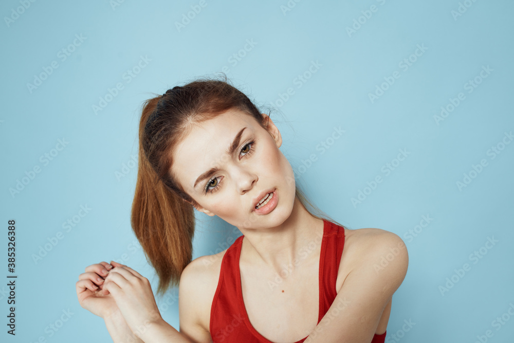 Sportive woman red tank top workout lifestyle gym blue background Sportive woman red tank top workout lifestyle gym blue background