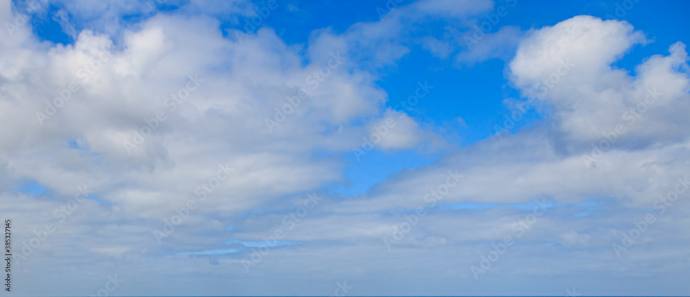 Image of a partly cloudy and partly clear sky during the day Image of a partly cloudy and partly clear sky during the day