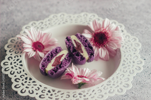 Macaroons. Delicious french desserts. Macaroons with flowers. Purple macaroons on the table