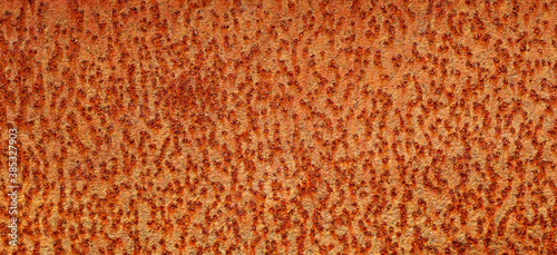 The background image of the iron sheet is rusting caused by prolonged use.Close up of black rust on an old sheet of metal texture.