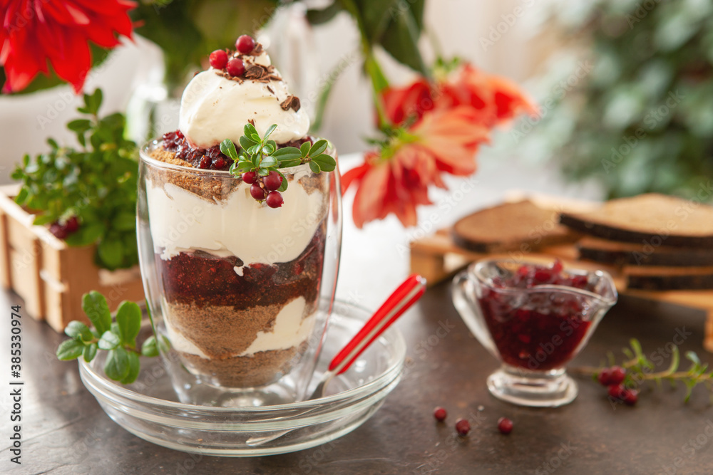Latvian,scandinavian traditional rye bread layered dessert with whipped cream and cowberry jam served in glass on a beautiful table setting Latvian,scandinavian traditional rye bread layered dessert with whipped cream and cowberry jam served in glass on a beautiful table setting