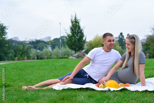 Guy and a pregnant girl on a picnic