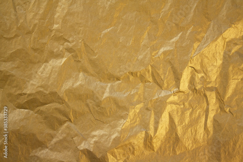 golden crumpled paper texture. paper background.