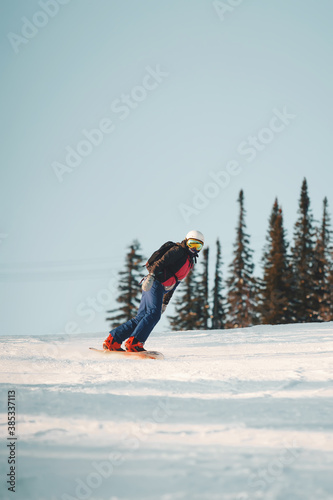 Photo of snowboarding female during vacation on winter resort photo
