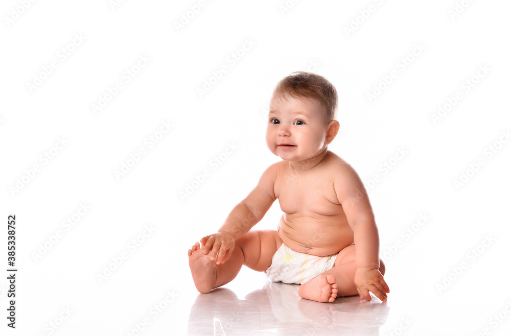 Smiling baby sitting on floor over white copyspace Smiling baby sitting on floor over white copyspace