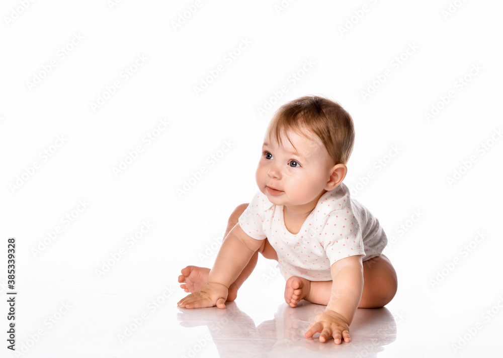 Cute little girl wearing a summer white bodysuit on a white background. Cute little girl wearing a summer white bodysuit on a white background.