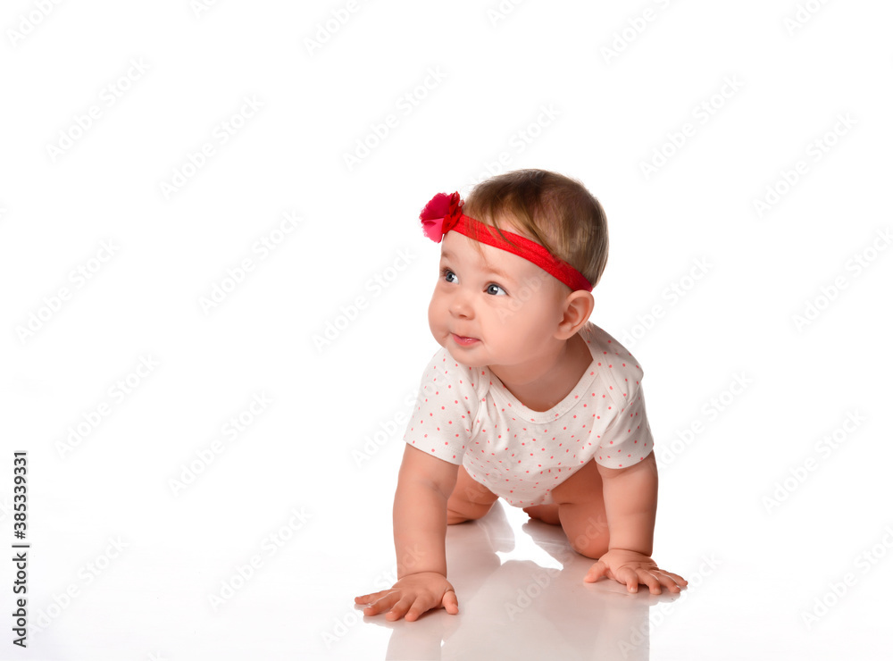 Portrait of a small baby girl crawling in the studio on a white background. Portrait of a small baby girl crawling in the studio on a white background.