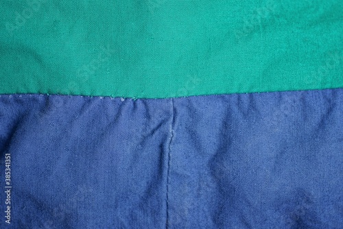 colored cloth texture of blue and green fabric with seams