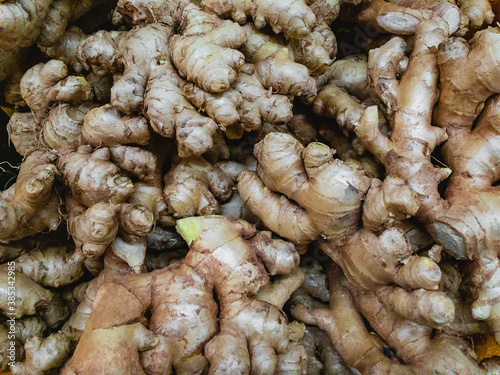 Raw ginger for sale lies in the supermarket. Close-up view.