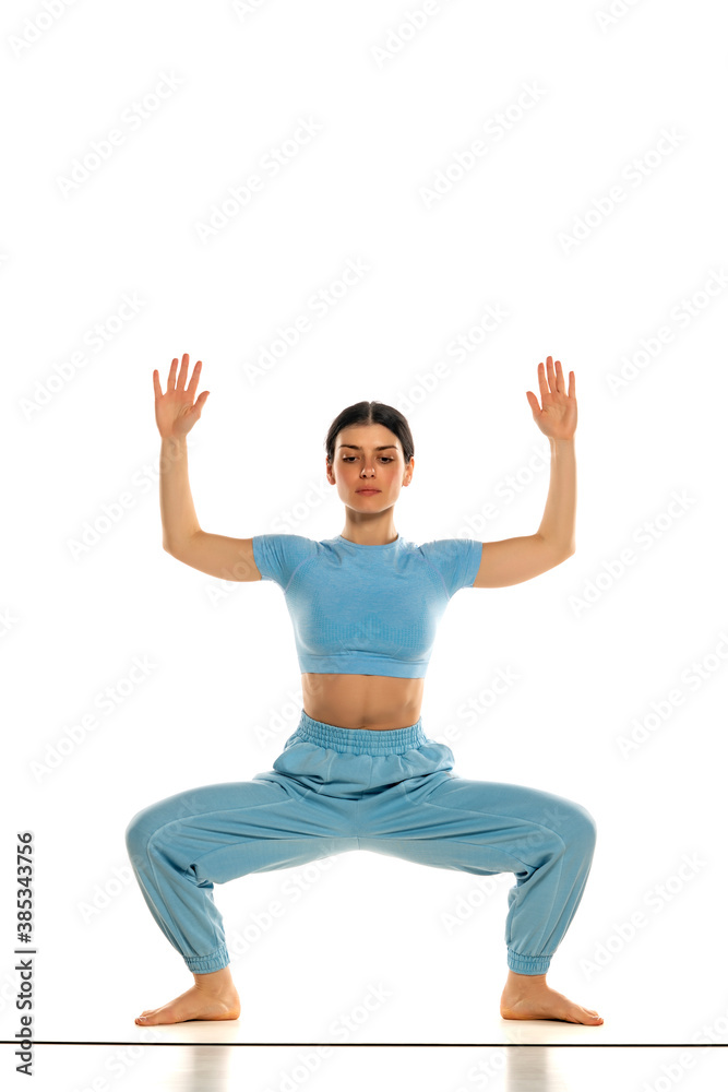Fit yoga woman doing yoga pose, isolated on white background. Fit yoga woman doing yoga pose, isolated on white background.