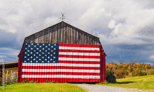 American flag painted on a farm barn during fall foliage season in New England
