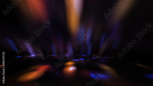 Multicolored neon shapes on a dark abstract background. Empty scene background, blurred neon ultraviolet light, bokeh.
