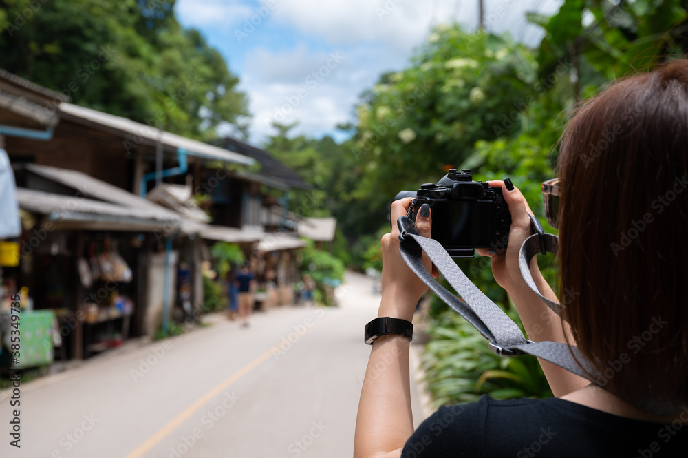 Young Asian woman photographing view of mountain in Mae Kampong Village Chiang mai Thailand Young Asian woman photographing view of mountain in Mae Kampong Village Chiang mai Thailand