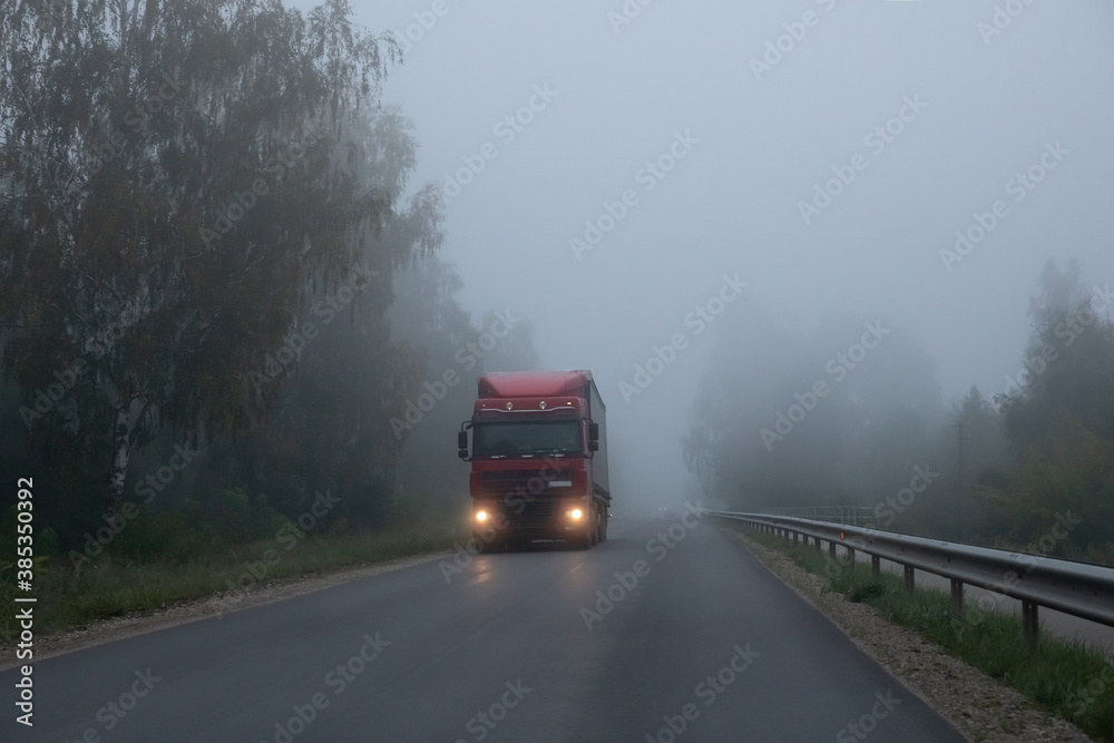 Truck on a rural road in the fog