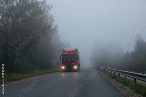 Truck on a rural road in the fog