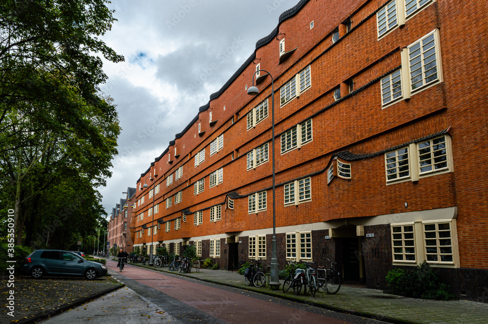AMSTERDAM, THE NETHERLANDS OCTOBER 07, 2020: Street vie of houses build in the architectural style 