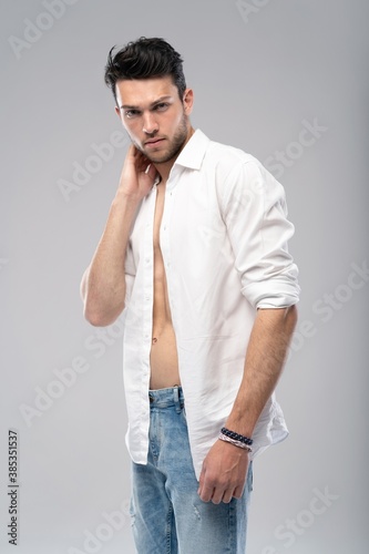 Obraz na plátně Portrait of a well built shirtless muscular male model against white background