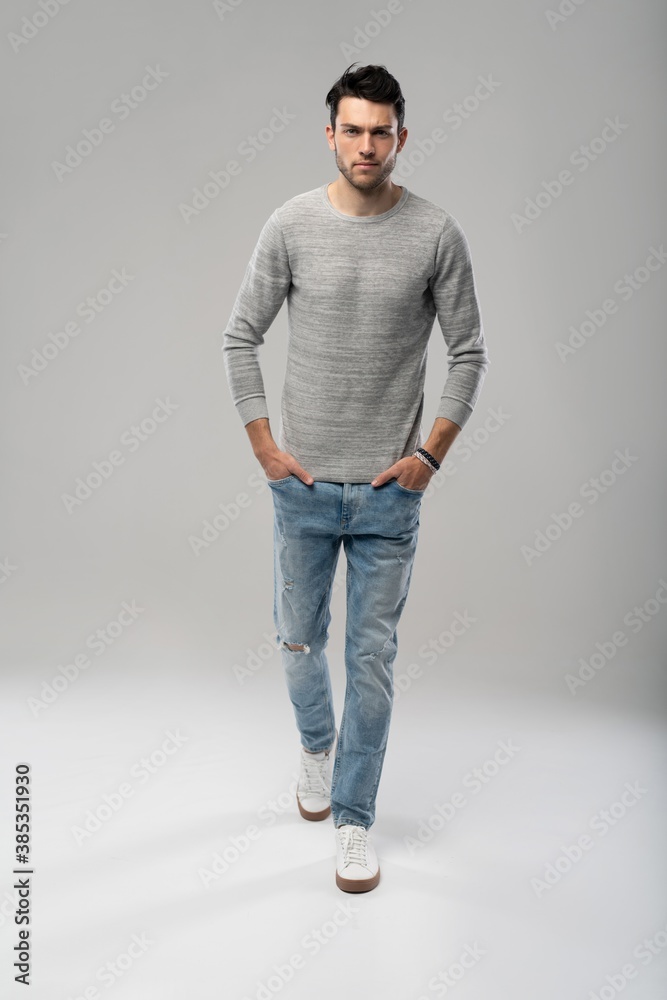 Handsome young man running or jumping in air on white background Handsome young man running or jumping in air on white background