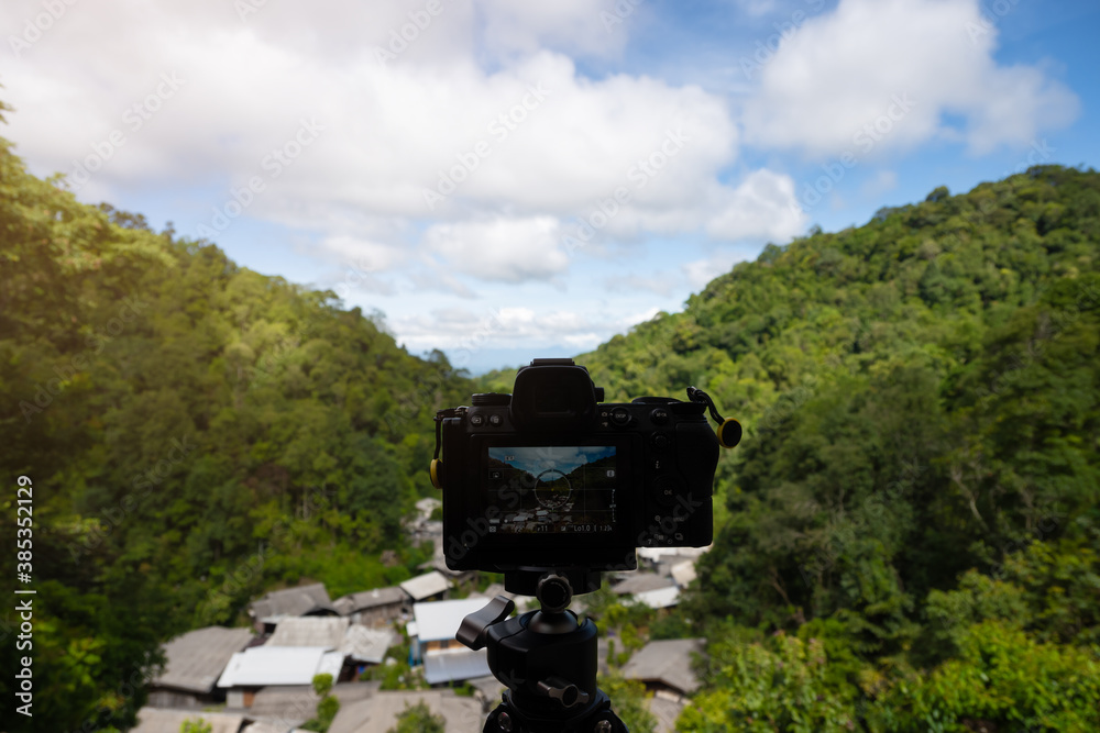 Photography digital camera on table with beautiful mountain view
