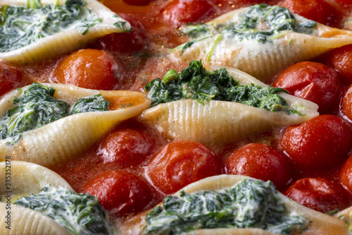 italian conchiglino pasta filled with spinach photo