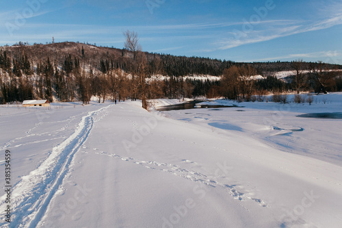 Open water in winter. Winter landscape on the river. Snow lies along the banks of the river.