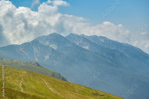 Wallpaper Mural Paragliders flying above the mountains close to Malcesine in Italy Torontodigital.ca
