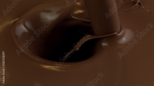 Detail of pouring hot chcocolate with splash photo