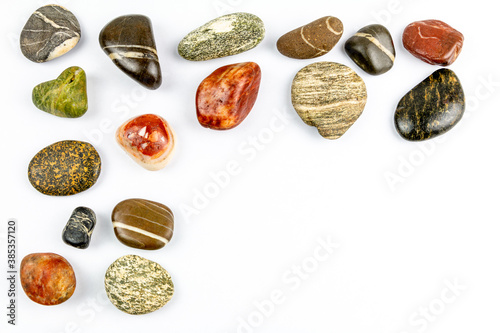 colored stones on white background with space