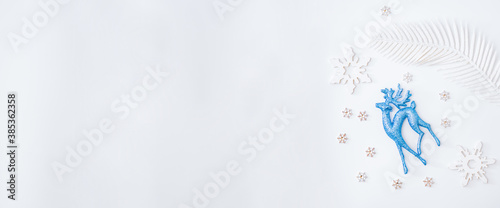 Flat lay frame with christmas baubles decoration and snowflakes on a white background