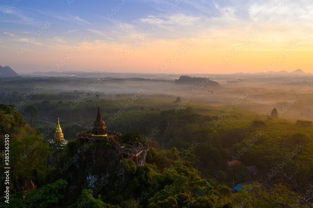 View of Buddhism temple Thamma Park padoga on hill at sunrise in Ban Khao Na Nai village in Phanom, Surat Thani, Thailand