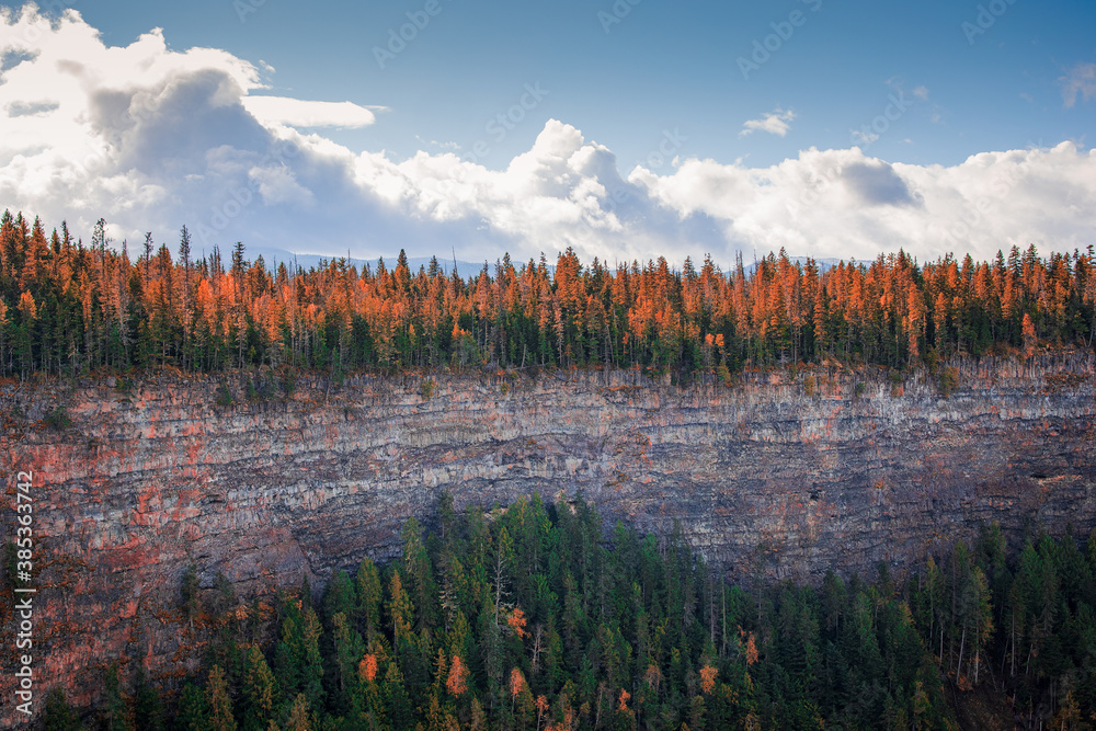 Autumn colors forest along mountain ledge