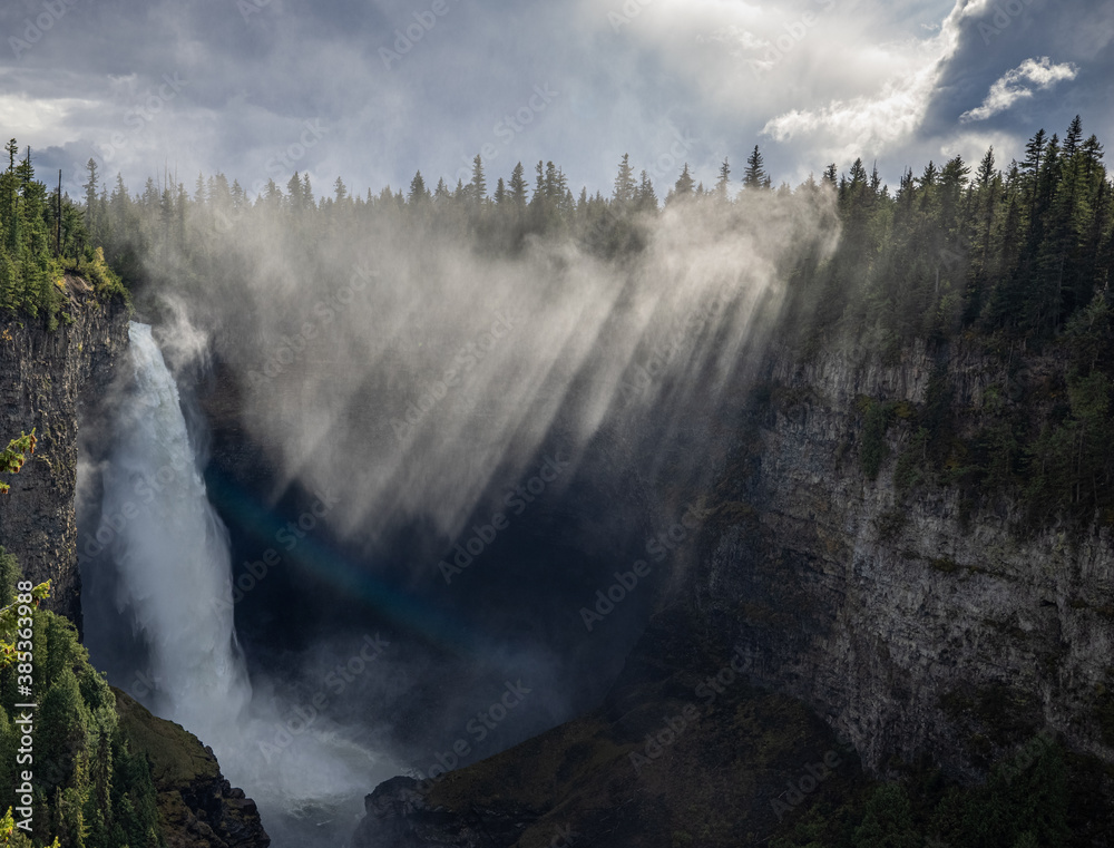 Sun breaks through to light up Helmcken Falls waterfall