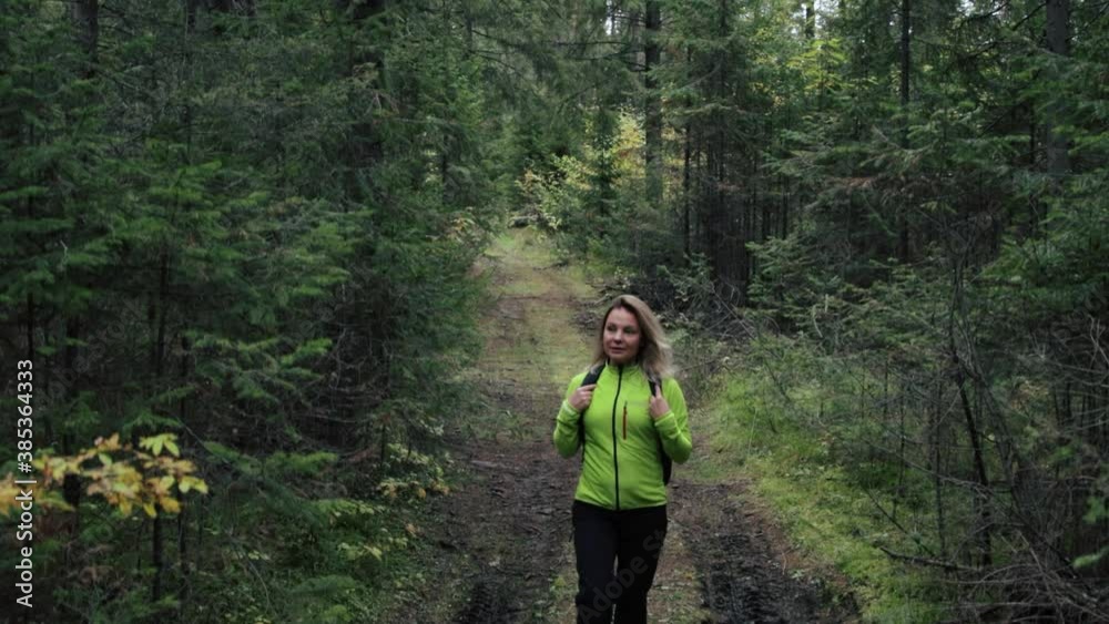 Woman tourist walking through the forest Woman tourist walking through the forest