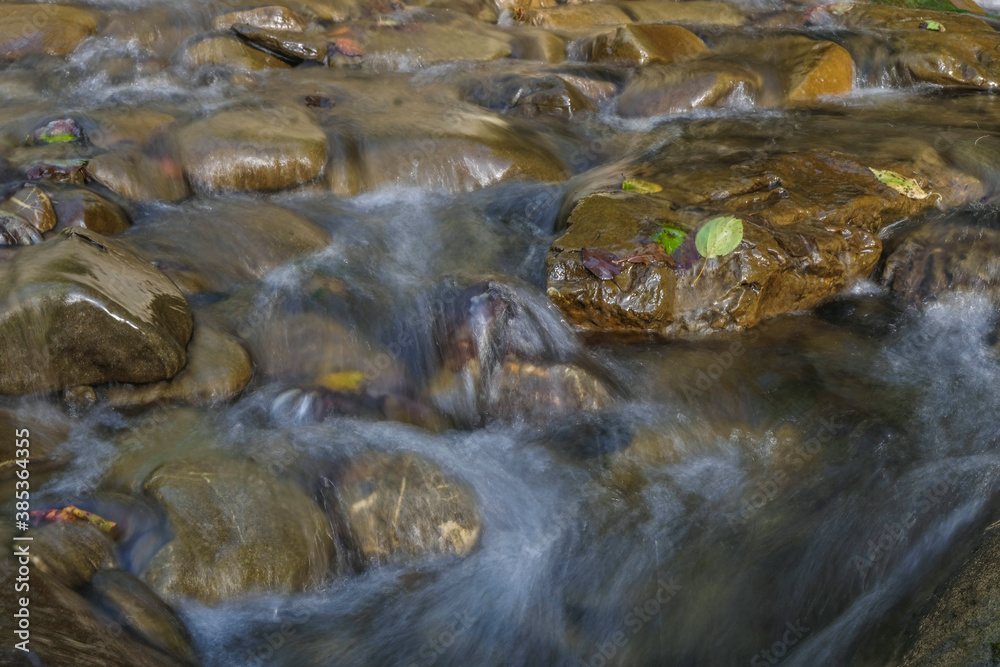 Clear water of the Carpathian mountain river. Long exposure photography. Evening golden hour. Clear water of the Carpathian mountain river. Long exposure photography. Evening golden hour.