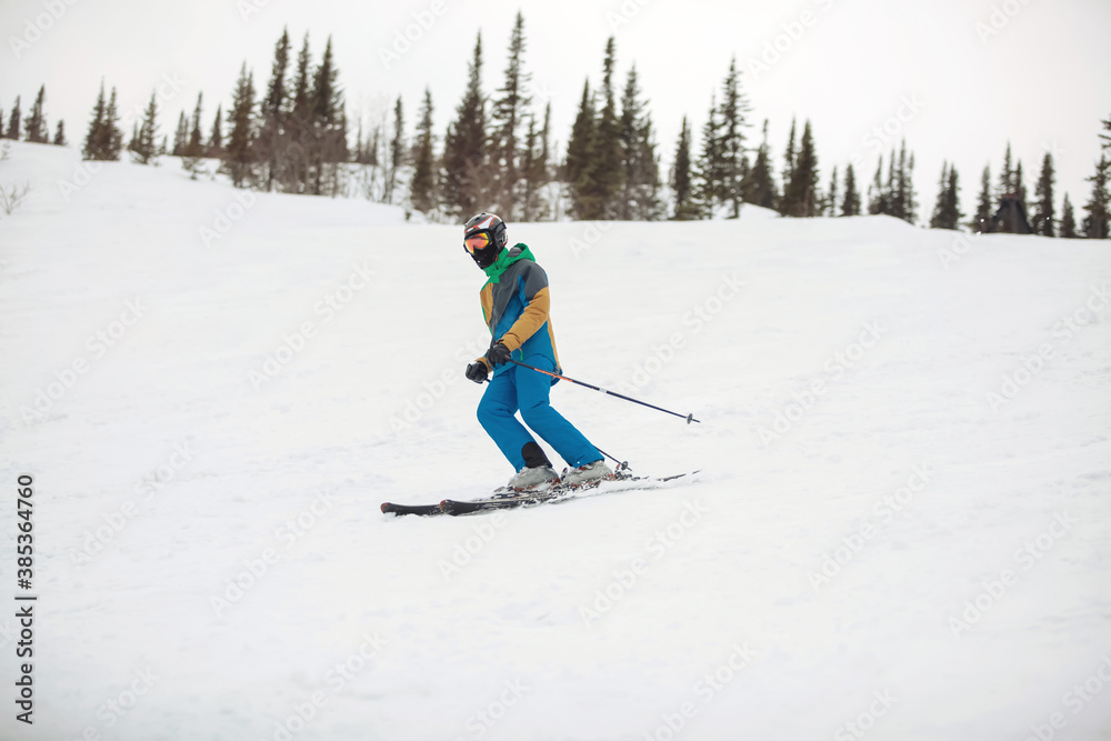 Skier in mountains on snowy slope Skier in mountains on snowy slope