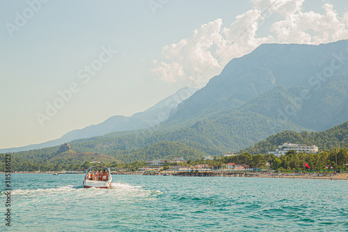 Fast boat on blue sea with mountain view, Kemer, Turkey