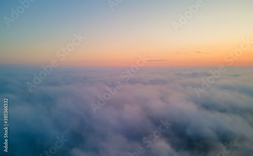 Drone view to the sunrise over the clouds