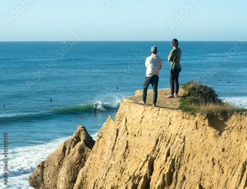 Viewers on top of a cliff check out the surf below. Montauk New York.