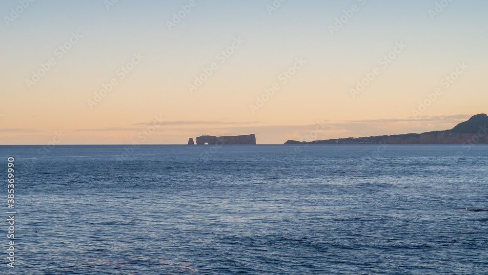 Famous rock of Percé in the horizon during the golden hour