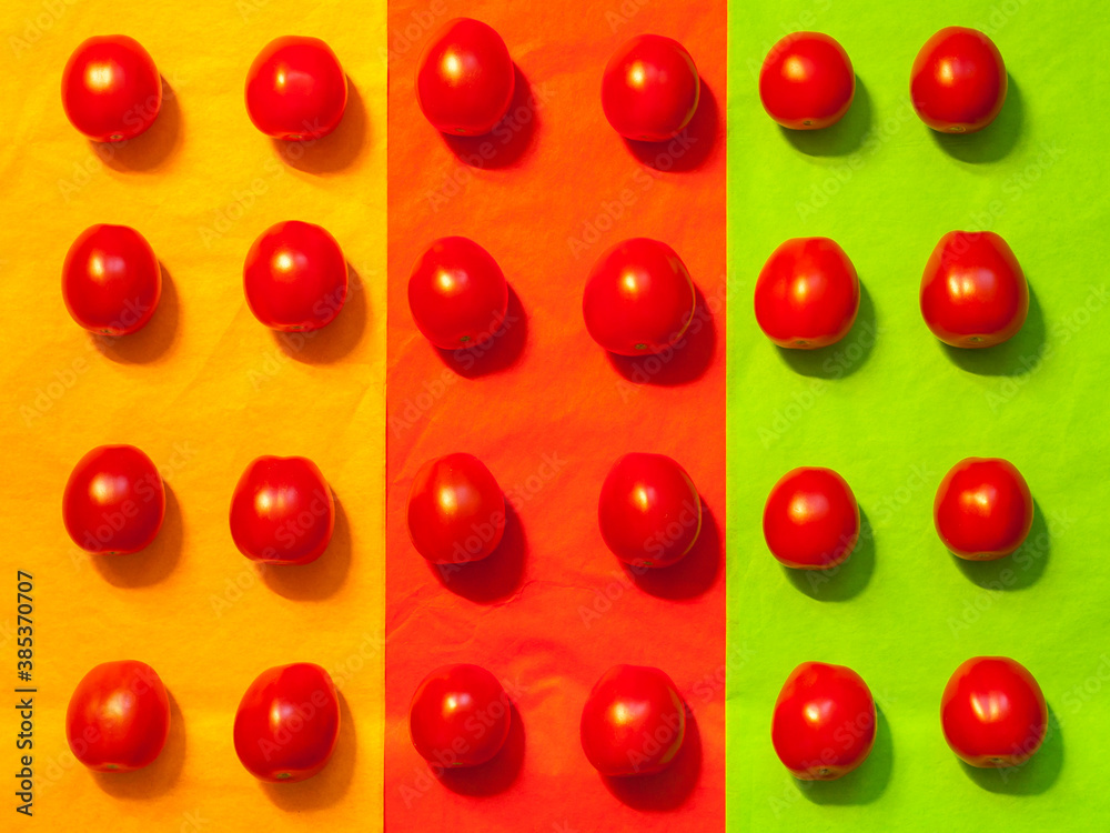 Juicy tomatoes on a colored paper background Juicy tomatoes on a colored paper background