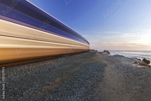 High Speed Coaster Train passing through Del Mar Heights along Pacific Coastline in San Diego County Southern California