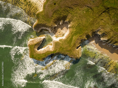 Aerial view of waves crashing on chalk cliffs along Selwicks Bay, UK. photo