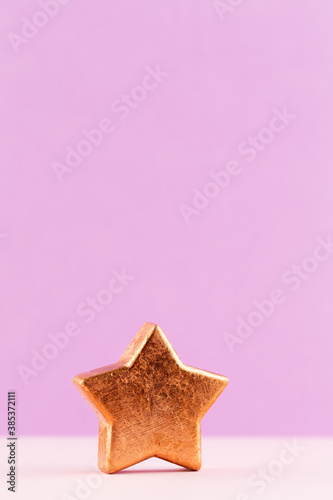 Christmas star  decor on pastel colored background. Christmas or New Year minimal concept.