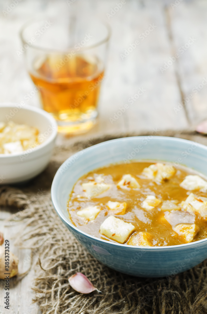 Saag Paneerin a bowl on a wood background Saag Paneerin a bowl on a wood background